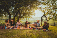 Group of friends eating in the nature
